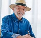 Lula assinando documento.
