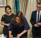 Raquel Lyra assinando documento no Pal&aacute;cio do Governo.