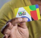 Homem segurando cart&atilde;o do Bolsa Fam&iacute;lia.