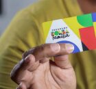 Pessoa segurando cart&atilde;o do Bolsa Fam&iacute;lia.