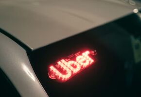 Carro com identifica&ccedil;&atilde;o do aplicativo da Uber.