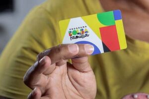 Pessoa segurando cart&atilde;o do Bolsa Fam&iacute;lia.