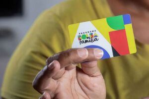 Pessoa segurando cart&atilde;o do Bolsa Fam&iacute;lia.