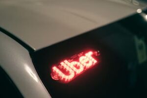 Carro com identifica&ccedil;&atilde;o do aplicativo da Uber.