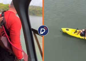 Agente no helic&oacute;ptero do GTA se preparando para resgate e pessoa &agrave; deriva em caiaque, na Barragem do Pirapama, Cabo de Santo Agostinho.