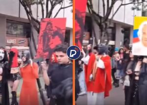 Vestidos de preto e mascarados, grupo LGBT+ realiza prociss&atilde;o com encena&ccedil;&atilde;o da crucifica&ccedil;&atilde;o de Jesus