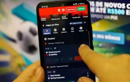 Pessoa apostando em bet, no celular.