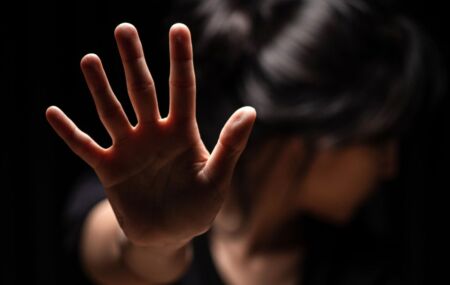 imagem ilustrativa de uma mulher com a m&atilde;e para frente, simulando uma tentativa de estupro.