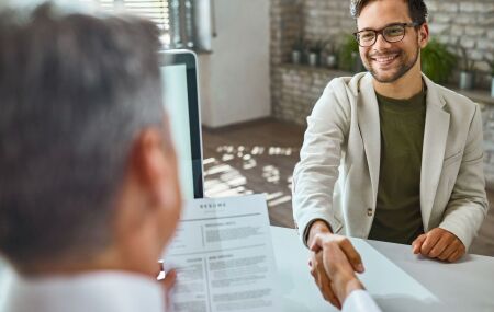 Candidato participa de entrevista de emprego em ambiente corporativo.