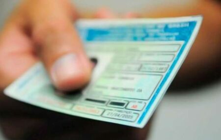 Pessoa segurando CNH.