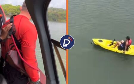 Agente no helic&oacute;ptero do GTA se preparando para resgate e pessoa &agrave; deriva em caiaque, na Barragem do Pirapama, Cabo de Santo Agostinho.