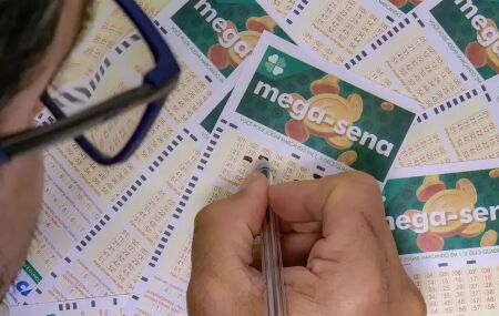 Pessoa marcando cartela da Mega-Sena.